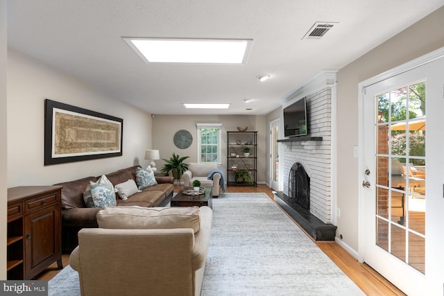 10808 Fieldwood Dr, Fairfax, VA 22030 - living area featuring light wood-type flooring, a fireplace, and baseboards