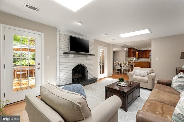 10808 Fieldwood Dr, Fairfax, VA 22030 - living room with light wood-style floors, a brick fireplace, a skylight, and recessed lighting