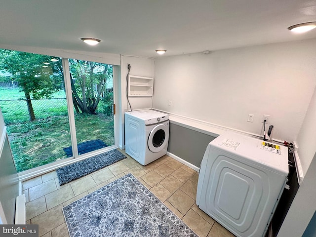 washroom featuring independent washer and dryer and light tile patterned floors