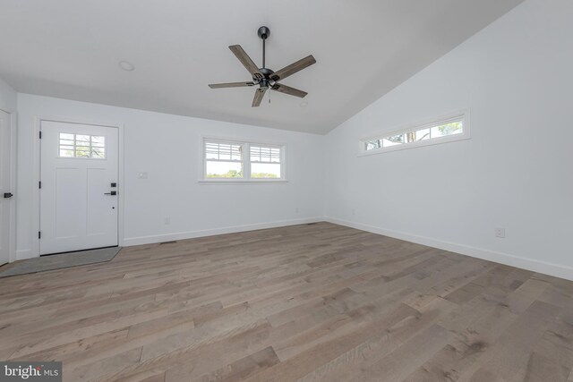 entryway featuring ceiling fan, baseboards, light wood finished floors, and high vaulted ceiling