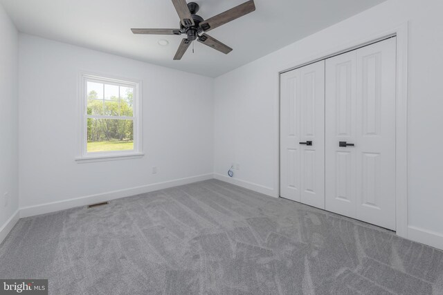 unfurnished bedroom with carpet floors, baseboards, a closet, and visible vents