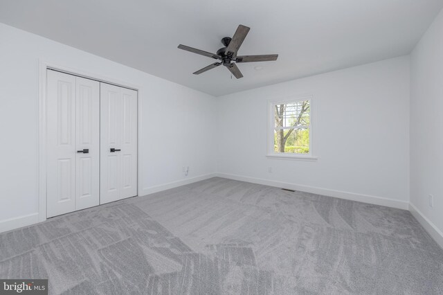 unfurnished bedroom featuring a closet, baseboards, carpet flooring, and visible vents