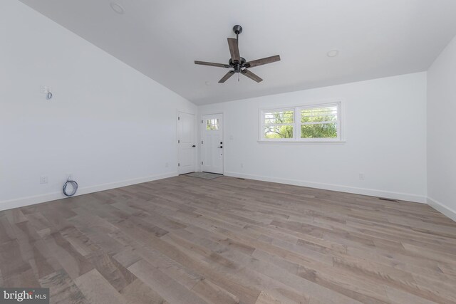 unfurnished living room with baseboards, a ceiling fan, wood finished floors, and lofted ceiling