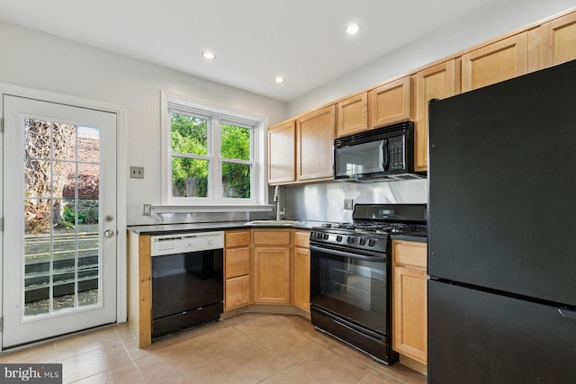 418 Monastery Ave, Philadelphia, PA 19128 - kitchen featuring light tile patterned flooring, dark countertops, a sink, recessed lighting, and black appliances