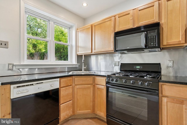 418 Monastery Ave, Philadelphia, PA 19128 - kitchen with light tile patterned floors, dark countertops, a sink, and black appliances