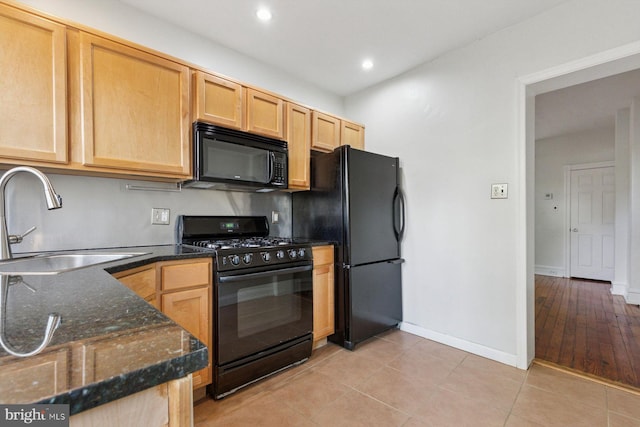 418 Monastery Ave, Philadelphia, PA 19128 - kitchen with a sink, dark stone counters, light brown cabinetry, and black appliances