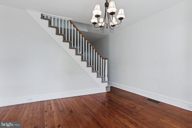 418 Monastery Ave, Philadelphia, PA 19128 - stairway featuring baseboards, visible vents, hardwood / wood-style floors, and an inviting chandelier
