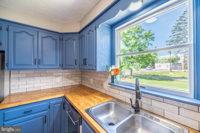 475 Farmington Ave, Pottstown, PA 19464 - kitchen with wooden counters, a sink, decorative backsplash, a textured ceiling, and blue cabinets