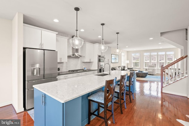 20790 Duxbury Ter, Ashburn, VA 20147 - kitchen featuring appliances with stainless steel finishes, recessed lighting, white cabinets, backsplash, and an island with sink