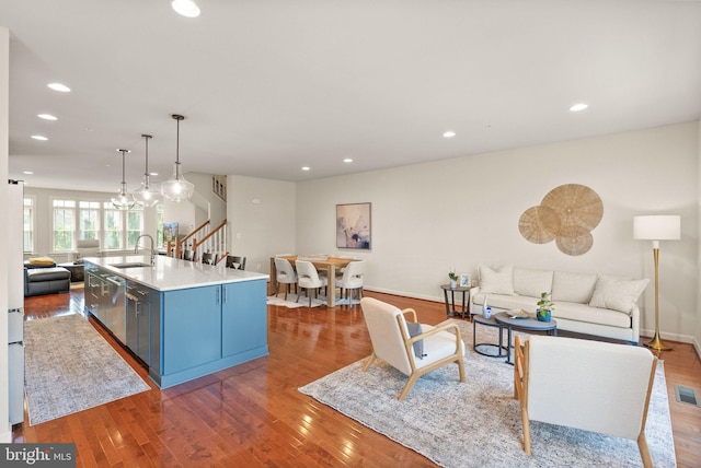 20790 Duxbury Ter, Ashburn, VA 20147 - living room featuring stairway, wood finished floors, and recessed lighting