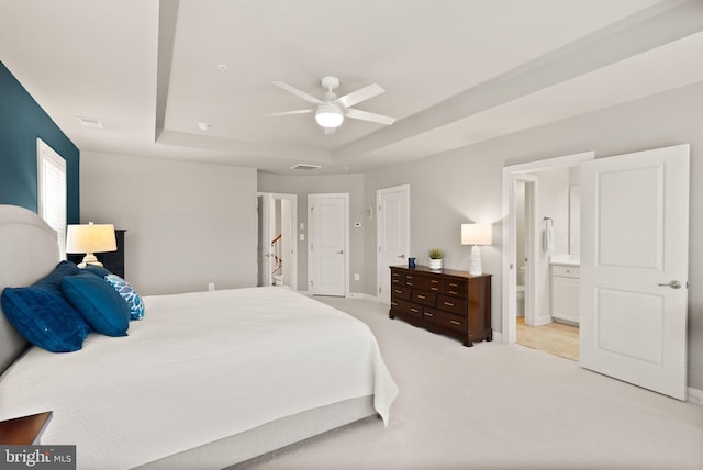 20790 Duxbury Ter, Ashburn, VA 20147 - bedroom featuring light carpet, a tray ceiling, connected bathroom, and ceiling fan