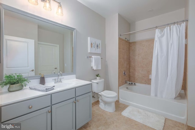 full bathroom featuring vanity, toilet, tile patterned floors, baseboards, and shower / tub combo