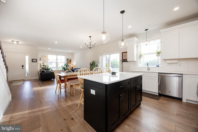 kitchen featuring stainless steel dishwasher, dark cabinets, recessed lighting, and light countertops