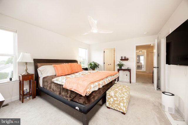 bedroom with baseboards, light carpet, and a ceiling fan