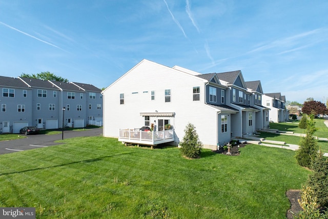 rear view of house with a residential view and a yard