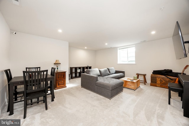 living room with recessed lighting and light colored carpet