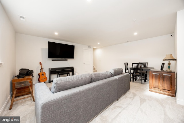 living area featuring visible vents, recessed lighting, stairs, and light colored carpet