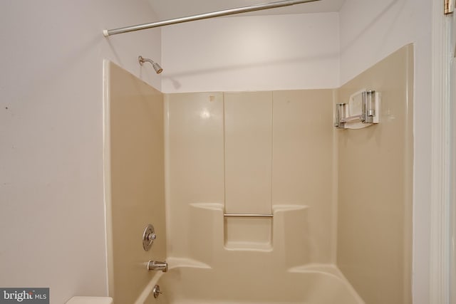 bathroom featuring toilet and tub / shower combination