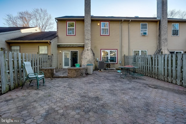 rear view of house with a patio and a fenced backyard