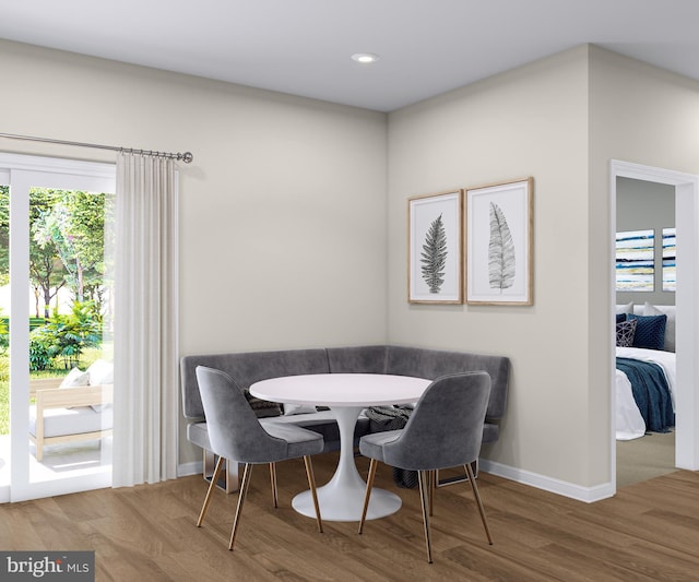 dining space featuring recessed lighting, baseboards, wood finished floors, and a healthy amount of sunlight