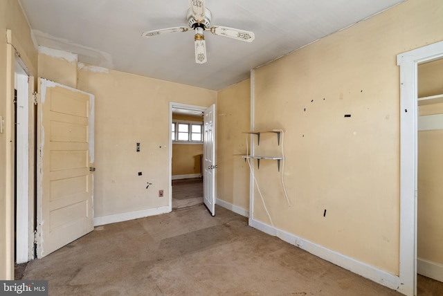 empty room featuring baseboards and a ceiling fan