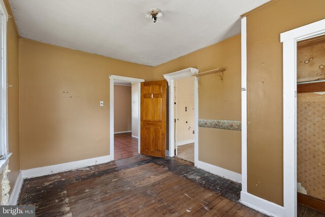 unfurnished bedroom featuring baseboards and wood finished floors