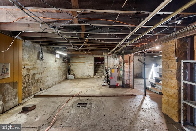 unfinished below grade area featuring stairs and a heating unit
