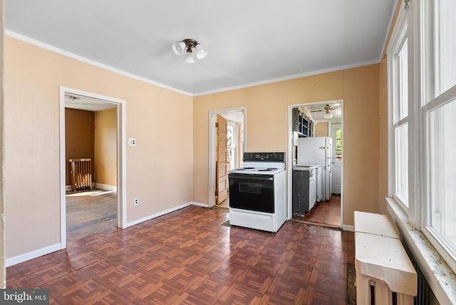 kitchen featuring white appliances, baseboards, and ornamental molding