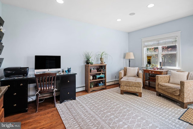 home office featuring a baseboard radiator, recessed lighting, and wood finished floors