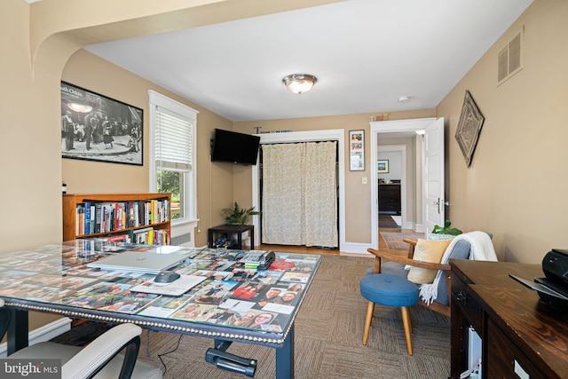 home office featuring visible vents, arched walkways, and baseboards