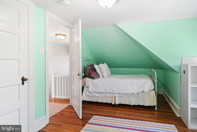 bedroom featuring baseboards and wood finished floors