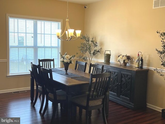 dining room with baseboards, a notable chandelier, dark wood-type flooring, and visible vents