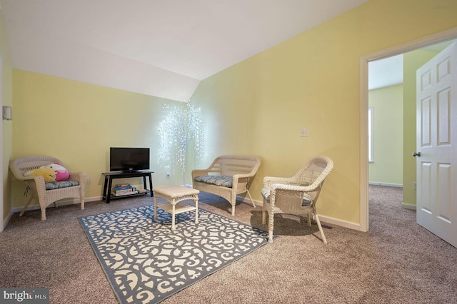 sitting room with vaulted ceiling, baseboards, and carpet flooring