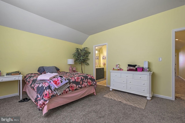 carpeted bedroom featuring baseboards, ensuite bath, and lofted ceiling