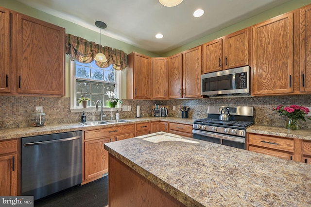 kitchen with hanging light fixtures, tasteful backsplash, a sink, stainless steel appliances, and recessed lighting
