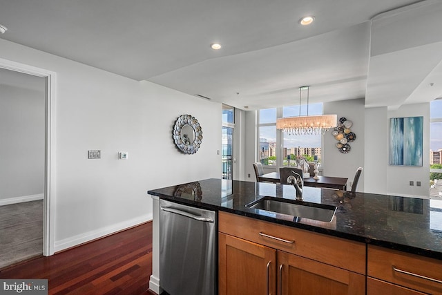 kitchen featuring a sink, brown cabinetry, dark stone counters, recessed lighting, and dark wood-type flooring
