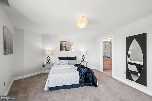 bedroom featuring carpet floors, baseboards, and connected bathroom