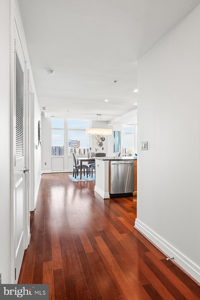 hall featuring baseboards and dark wood-style floors