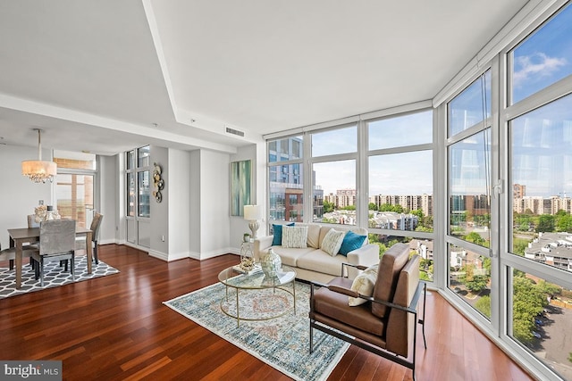 living room with a view of city, baseboards, wood finished floors, and visible vents