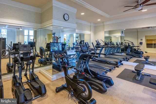 workout area featuring ceiling fan and ornamental molding