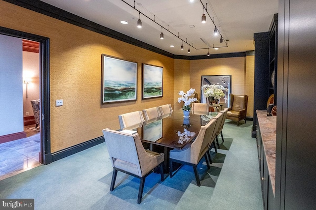 dining space featuring baseboards and track lighting