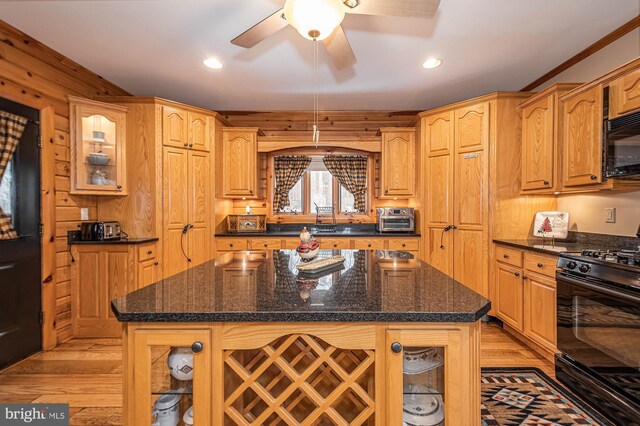 kitchen with glass insert cabinets, ceiling fan, black appliances, and light wood-type flooring