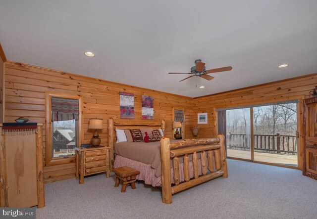 carpeted bedroom with recessed lighting, wood walls, and access to exterior