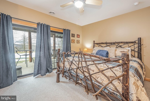 carpeted bedroom with access to outside, ceiling fan, and visible vents