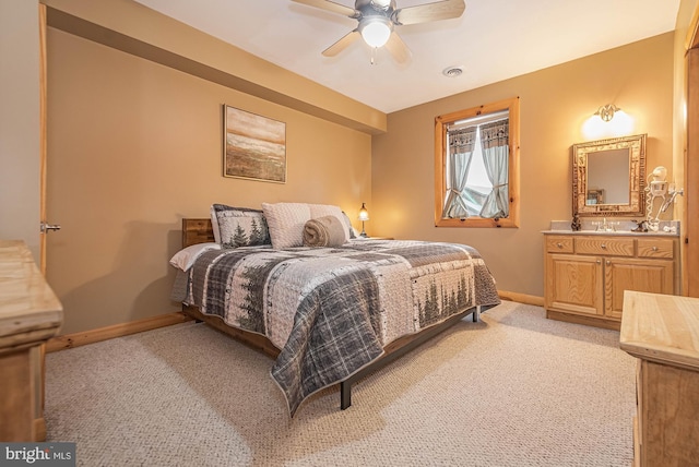 bedroom featuring light colored carpet, baseboards, ceiling fan, and visible vents