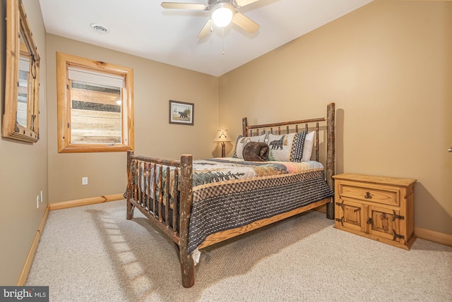 bedroom featuring baseboards, visible vents, light carpet, and ceiling fan