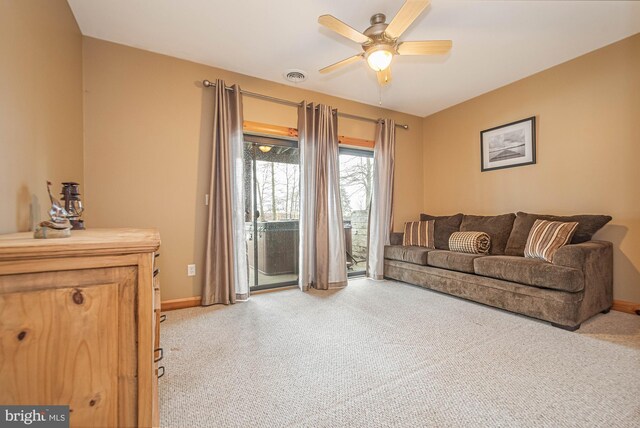carpeted living room featuring baseboards, a ceiling fan, and visible vents