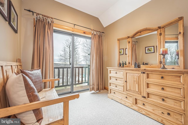 sitting room featuring carpet and vaulted ceiling