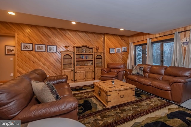 living room with recessed lighting and wood walls