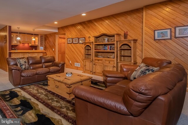 living area featuring visible vents, wood walls, carpet floors, and recessed lighting